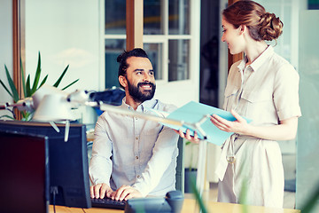 Image showing business team with computer and files in office