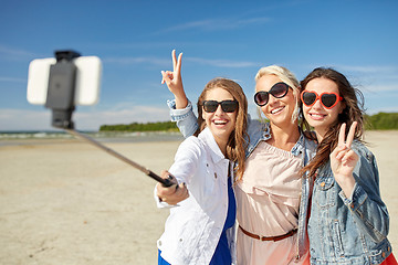 Image showing group of smiling women taking selfie on beach