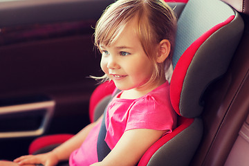 Image showing happy little girl sitting in baby car seat