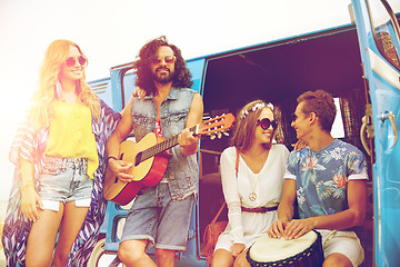 Image showing happy hippie friends playing music over minivan