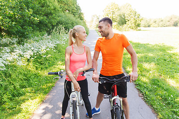 Image showing happy couple riding bicycle outdoors