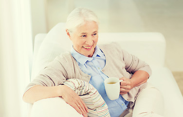 Image showing happy senior woman with cup of tea at home