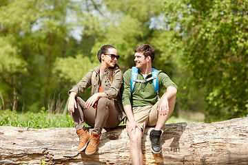 Image showing smiling couple with backpacks in nature