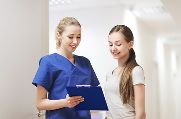 Image showing doctor or nurse with clipboard and girl patient