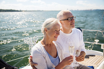 Image showing senior couple drinking champagne on sail boat