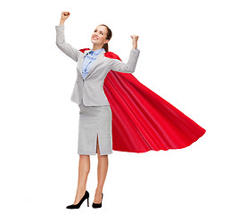 Image showing young smiling businesswoman in red superhero cape