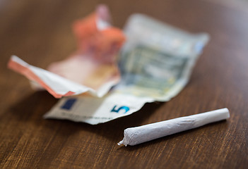 Image showing close up of marijuana joint and money