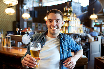 Image showing happy man drinking draft beer at bar or pub