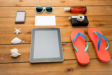 Image showing close up of tablet pc and travel stuff