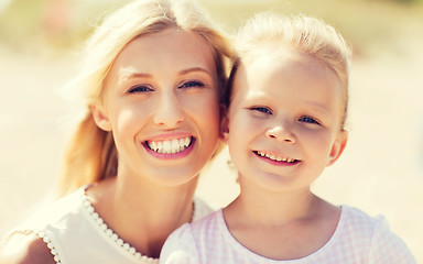 Image showing happy mother and little daughter on summer beach