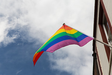 Image showing close up of rainbow gay pride flag waving on building