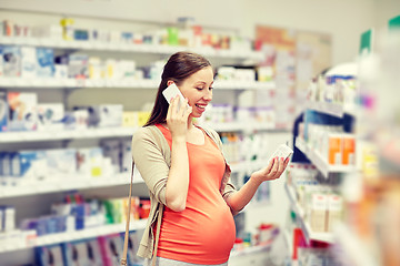Image showing happy pregnant woman with smartphone at pharmacy
