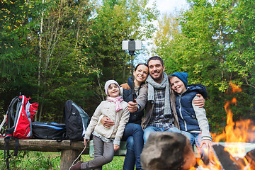 Image showing family with smartphone taking selfie near campfire