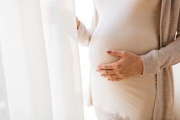 Image showing close up of pregnant woman belly and hands