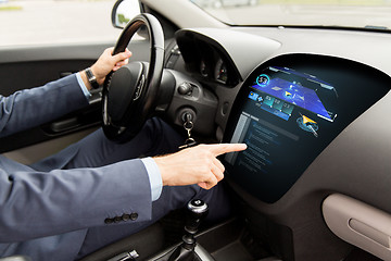 Image showing close up of man driving car with navigation system