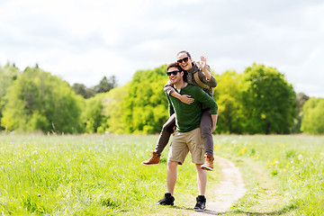 Image showing happy couple with backpacks having fun outdoors