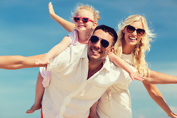 Image showing happy family having fun over blue sky background