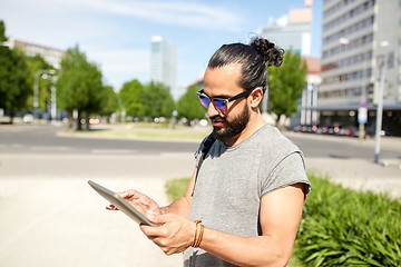 Image showing man traveling with backpack and tablet pc in city