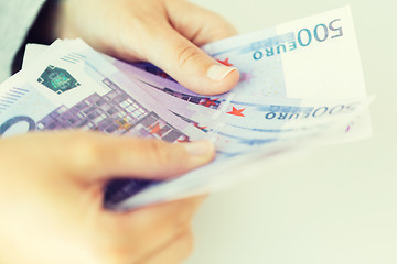 Image showing close up of woman hands counting euro money