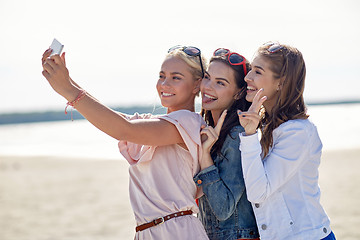 Image showing group of smiling women taking selfie on beach