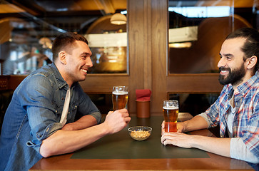 Image showing happy male friends drinking beer at bar or pub