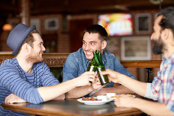 Image showing happy male friends drinking beer at bar or pub