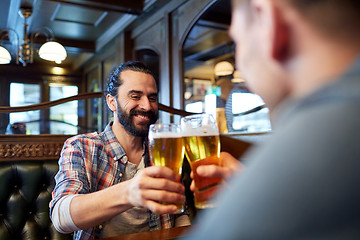 Image showing happy male friends drinking beer at bar or pub