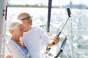 Image showing senior couple taking selfie on sail boat or yacht