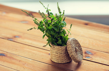 Image showing close up of melissa in basket on wooden table