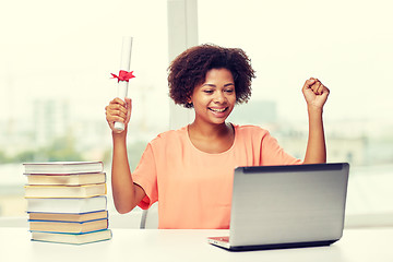 Image showing happy african woman with laptop, books and diploma