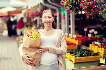 Image showing pregnant woman with bag of food at street market