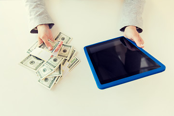 Image showing close up of woman hands with tablet pc and money