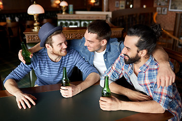 Image showing happy male friends drinking beer at bar or pub