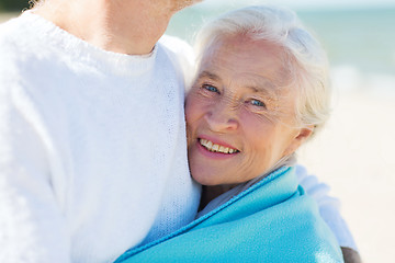 Image showing happy senior couple hugging on summer beach