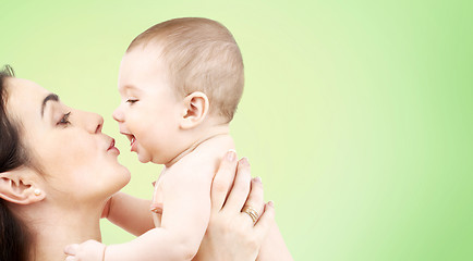 Image showing happy mother kissing adorable baby