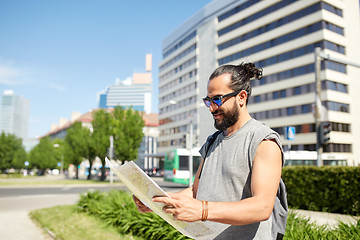 Image showing man traveling with backpack and map in city