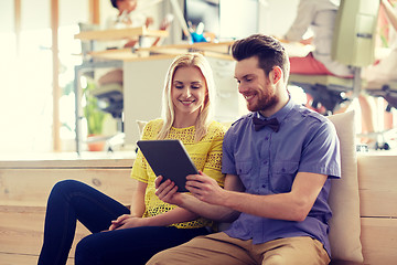 Image showing happy creative team with tablet pc in office