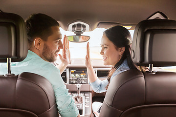 Image showing happy man and woman driving in car