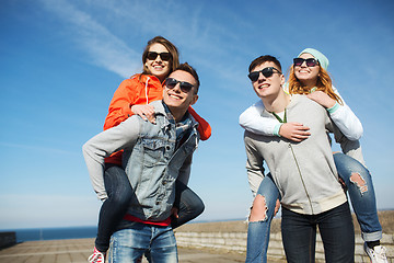 Image showing happy teenage friends in shades having fun outdoors