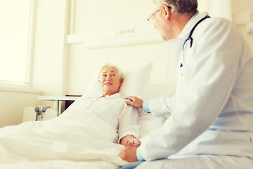 Image showing doctor visiting senior woman at hospital ward