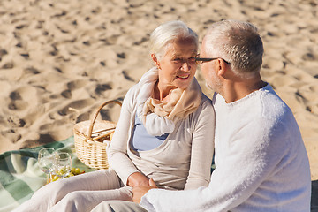 Image showing happy senior couple talking on summer beach