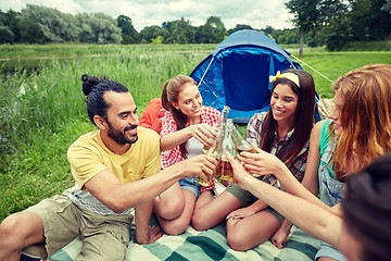Image showing happy friends with tent and drinks at campsite