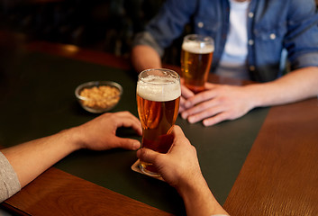 Image showing close up of men drinking beer at bar or pub