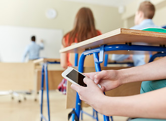 Image showing student boy with smartphone texting at school