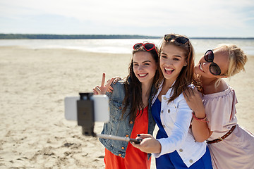 Image showing group of smiling women taking selfie on beach