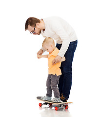 Image showing happy father and little son on skateboard