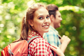 Image showing group of smiling friends with backpacks hiking