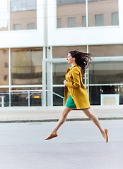 Image showing happy young woman or teenage girl on city street