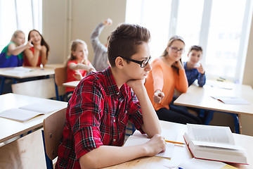 Image showing classmates laughing at student boy in school