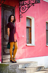 Image showing beautiful middle-aged woman in a burgundy dress